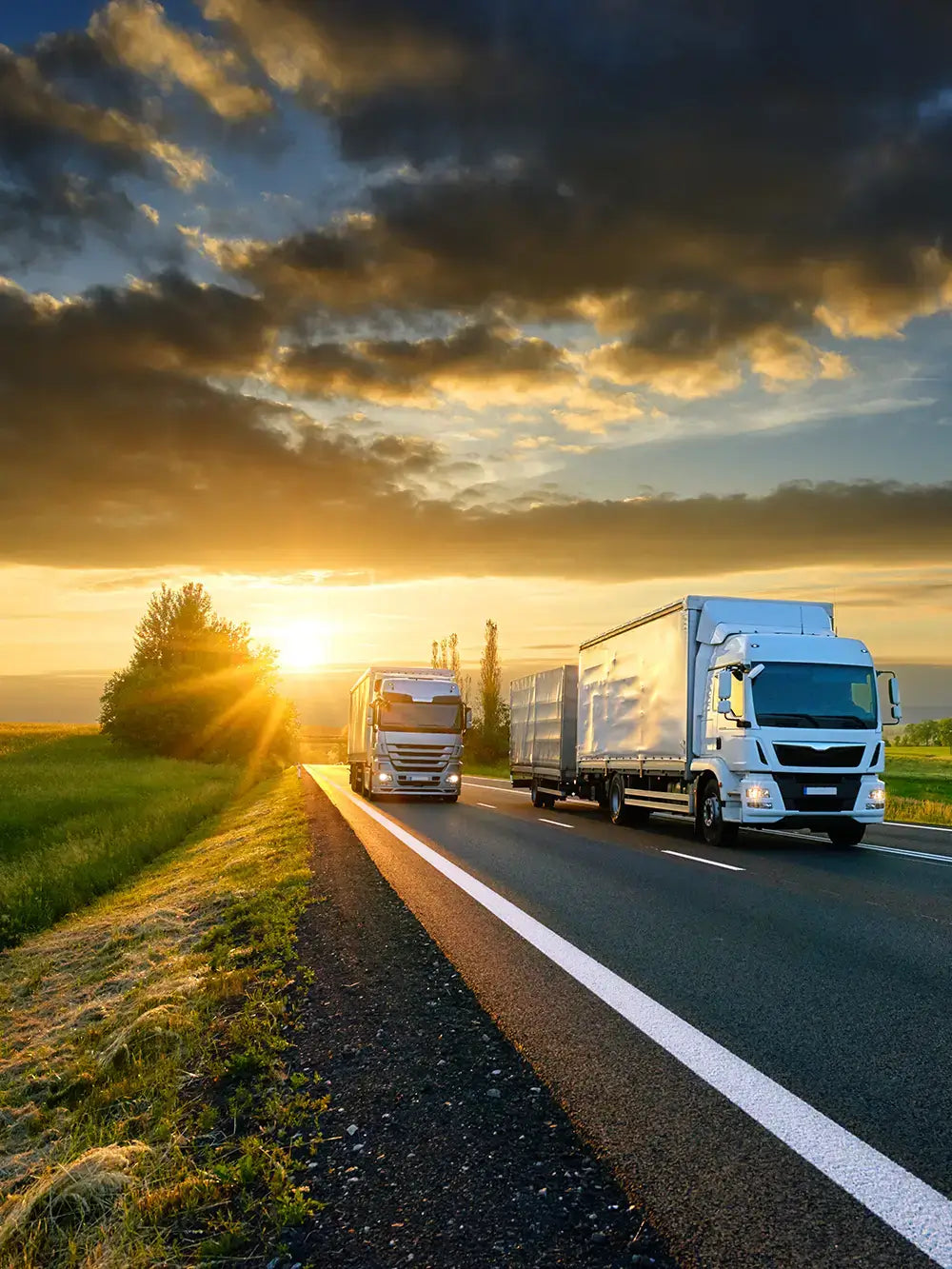 Fleet trucks on Australian highway at sunrise, tracked with Keep Track GPS fleet management and vehicle tracking solutions in Perth and nationwide